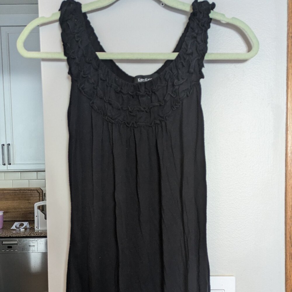 Black sleeveless top with ruffle neck